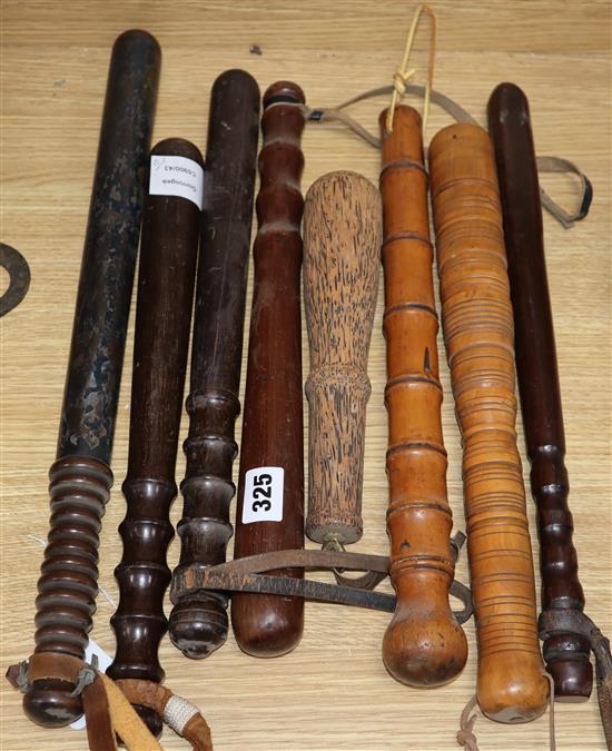 Seven treen truncheons and cocus wood priest, longest 48cm